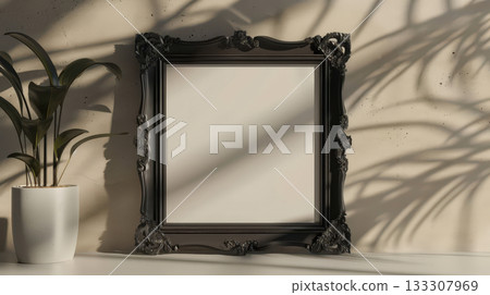 Ornate black picture frame with indoor plant 133307969