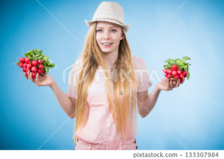 Young woman holding radish Young woman holding radish 133307984