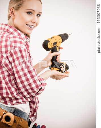 Girl using some power tools for work at home Girl using some power tools for work at home 133307988