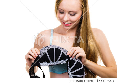 Woman trying on black bra with lace Woman trying on black bra with lace 133308005