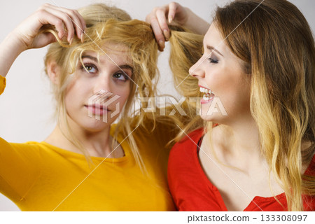 Two girls creating hairdo. Hair ombre color 133308097
