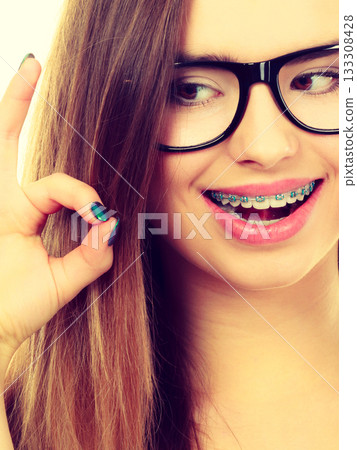 Happy nerdy teenage with brace wearing eyeglasses Happy nerdy teenage with brace wearing eyeglasses 133308428