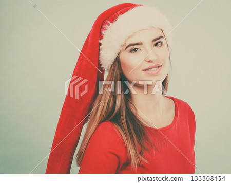 Positive woman wearing Santa Claus helper costume 133308454