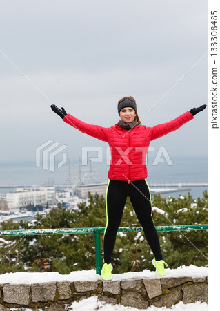 Woman wearing sportswear exercising during winter 133308485