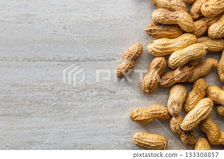 Peanuts in shell. Groundnuts on kitchen table. Top view. Peanuts in shell. Groundnuts on kitchen table. Top view. 133308857