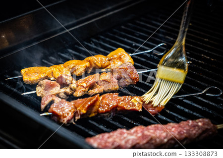 Grilled Kebab From Fresh Meat Pork Cooking On Metal Skewer Outdoors grill steak Grilled Kebab From Fresh Meat Pork Cooking On Metal Skewer Outdoors grill steak 133308873