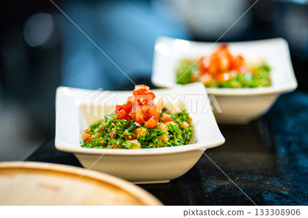 Waldorf salad with fresh apple, celery, lettuce, grilled chicken fillet, arugula and walnuts on plate, blue table background, side view Waldorf salad with fresh apple, celery, lettuce, grilled chicken fillet, arugula and walnuts on plate, blue table background, side view 133308906