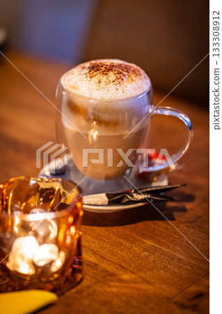Close up hot coffee latte in restaurant. Vertical 133308912