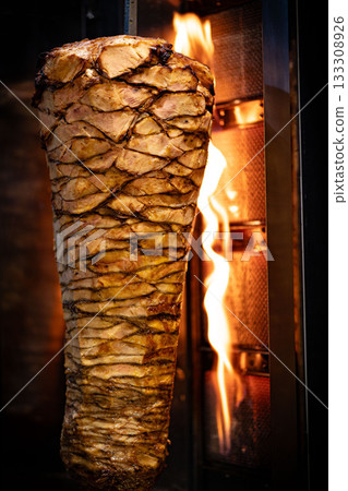 Traditional Turkish Doner Kebab meat. Shawarma or gyros. Turkish, greek or middle eastern arab style chicken doner kebab food in restaurant. Traditional Turkish Doner Kebab meat. Shawarma or gyros. Turkish, greek or middle eastern arab style chicken doner kebab food in restaurant. 133308926