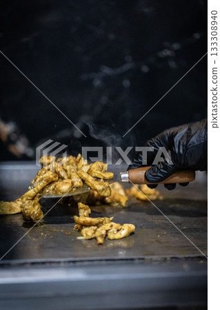 Close up photograph of chicken pieces on the barbecue grill 133308940