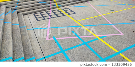 A picture capturing a number game for children on the floor drawn with chalk. The concept of children's leisure, outdoor recreation, and preschool education 133309486