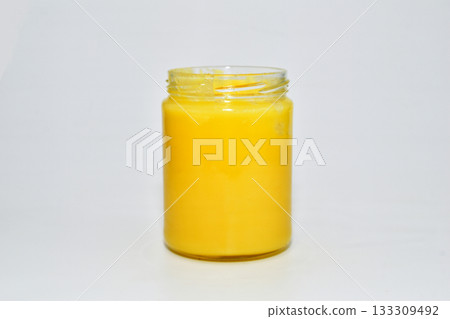 Yellow ghee in a glass jar. 133309492