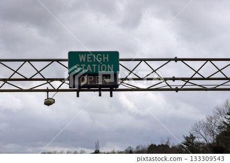 Weigh station sign displaying open status in rural area on American highway Weigh station sign displaying open status in rural area on American highway 133309543