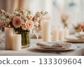 Beautiful dinner table decorated with pastel flowers, candles and glassware 133309604