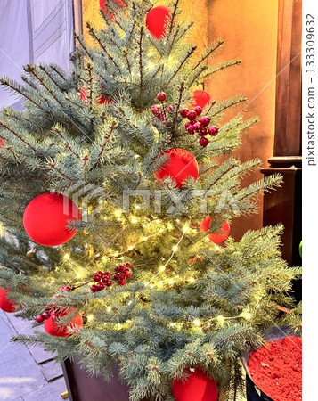 a beautiful Christmas tree decorated with Christmas balls and toys a beautiful Christmas tree decorated with Christmas balls and toys 133309632