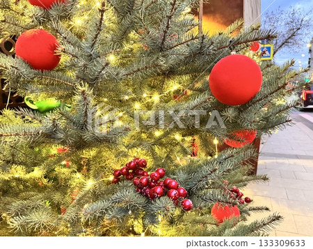 a beautiful Christmas tree decorated with Christmas balls and toys a beautiful Christmas tree decorated with Christmas balls and toys 133309633