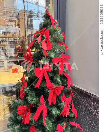 Christmas tree decorated with red bows 133309638