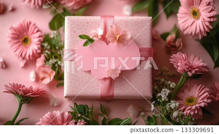 Elegant pink gift box with ribbon and rose decor surrounded by petals on a teal background. Great for birthdays, weddings or Valentine's. 133309691