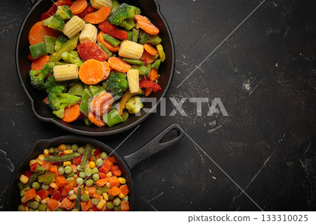 Frozen mixed vegetables two cast iron skillets black healthy cooking defrosting meal prep copy space 133310025