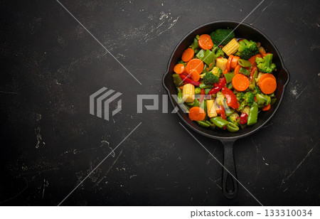 Stir fried colorful mixed vegetables cast iron skillet healthy cooking diet vegan copy space 133310034