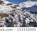 Flight over the famous village of Andermatt in Switzerland in winter - aerial photography 133310305