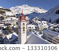 Flight over the famous village of Andermatt in Switzerland in winter - aerial photography 133310306