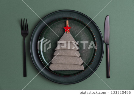 Elegant Christmas Table Setting with Napkin Tree and Red Star Ornament Elegant Christmas Table Setting with Napkin Tree and Red Star Ornament 133310496