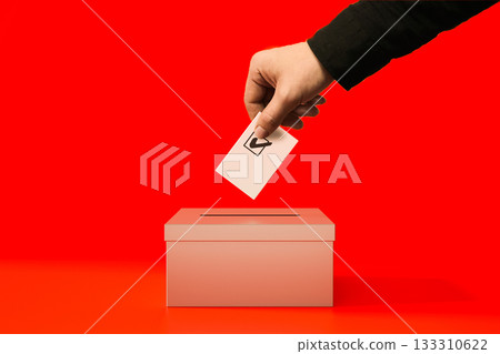 A person putting a voting card into a ren ballot box 133310622