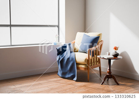 An armchair with a blue pillow and blanket is positioned in the corner  133310625