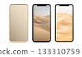 Three modern smartphones showing desert landscape wallpapers 133310759
