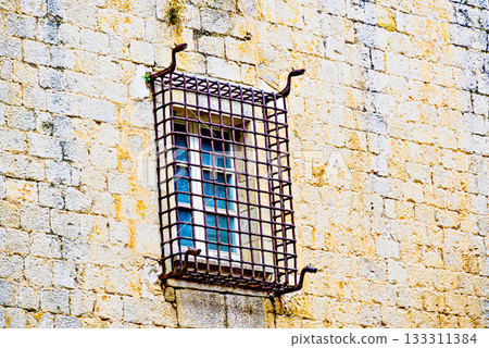 Window with iron bars on stone eall Window with iron bars on stone eall 133311384