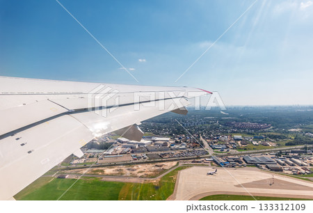 View from the airplane window during takeoff at Sheremetyevo airport at summer View from the airplane window during takeoff at Sheremetyevo airport at summer 133312109