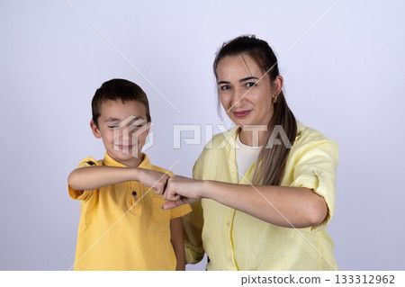 Woman and boy are performing a fist bump Woman and boy are performing a fist bump 133312962