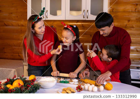 A family is baking Christmas cookies together in the kitchen 133312990