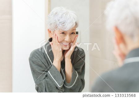 Senior woman doing skin care 133313568