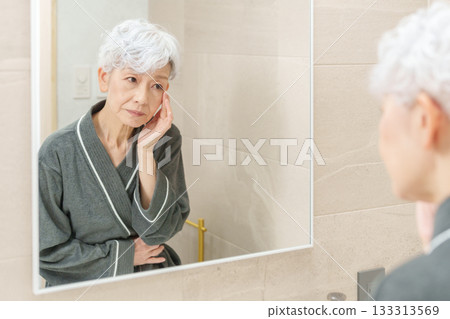 Senior woman doing skin care 133313569