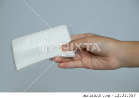 Hands handing over pocket tissues 133313587
