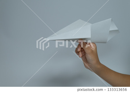 Hand holding a paper plane and copy space Hand holding a paper plane and copy space 133313656