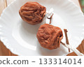 Two delicious dried persimmons arranged on a plate Two delicious dried persimmons arranged on a plate 133314014