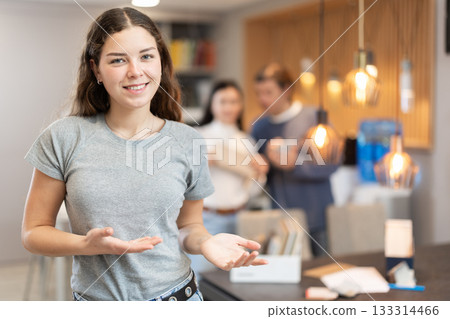 Portrait of friendly girl seller of furniture store Portrait of friendly girl seller of furniture store 133314466