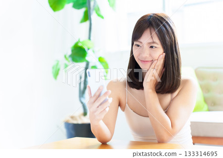 Woman using smartphone, beauty, facial, skin check, skin age Woman using smartphone, beauty, facial, skin check, skin age 133314695