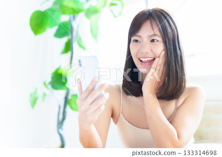 Woman using smartphone, beauty, facial, skin check, skin age 133314698