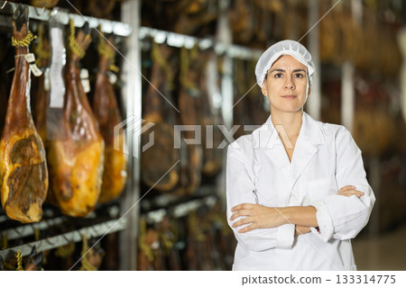 woman in a bathrobe working in a jamon factory 133314775