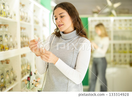 Smiling woman looking perfume for in perfume modern beauty shop 133314928