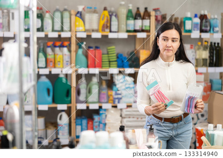 Woman choosing hair shaving machines in supermarket 133314940
