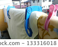 On a nice, sunny morning, hang your futon out on the balcony and make sure to secure it with futon clips. 133316018