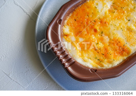 A close-up photo of a golden brown gratin. 133316064