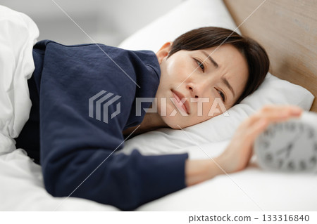 Woman sleeping in bed, alarm, oversleep Woman sleeping in bed, alarm, oversleep 133316840