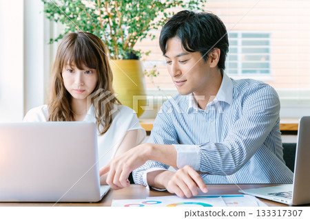 Young men and women working in the office 133317307