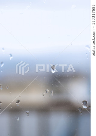Water droplets on the window on a rainy day Water droplets on the window on a rainy day 133317683